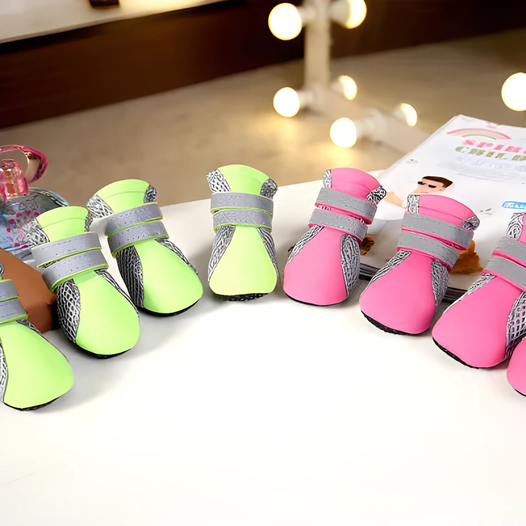 Set of four waterproof dog shoes in pink with reflective detailing and rubber soles