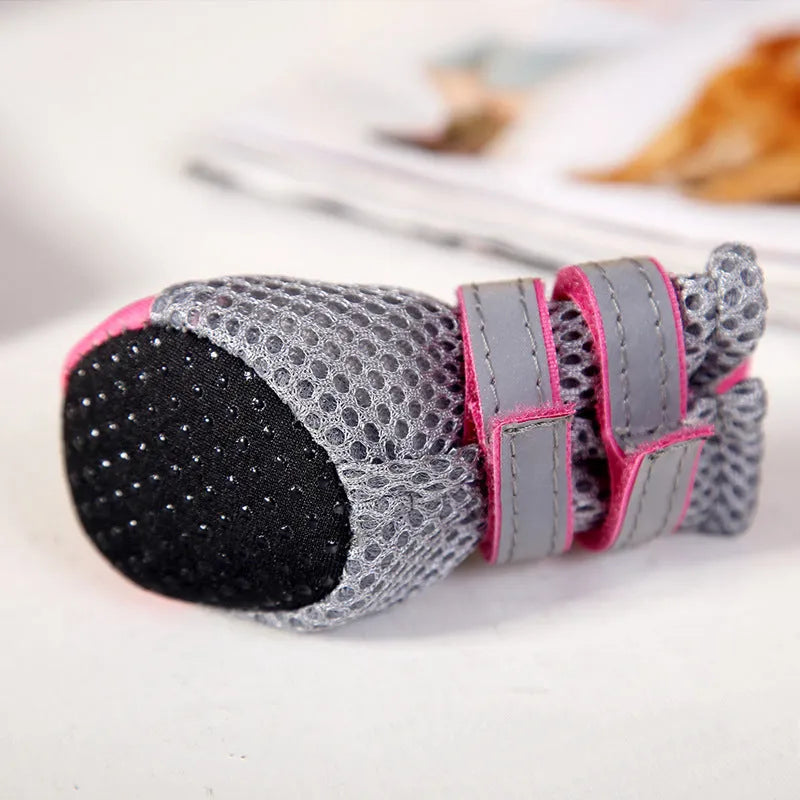 Set of four waterproof dog shoes in pink with reflective detailing and rubber soles
