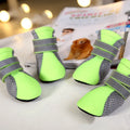Set of four waterproof dog shoes in pink with reflective detailing and rubber soles