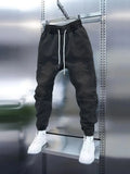 Men's light blue denim pencil pants with elastic ankle bands and drawstring mid waist