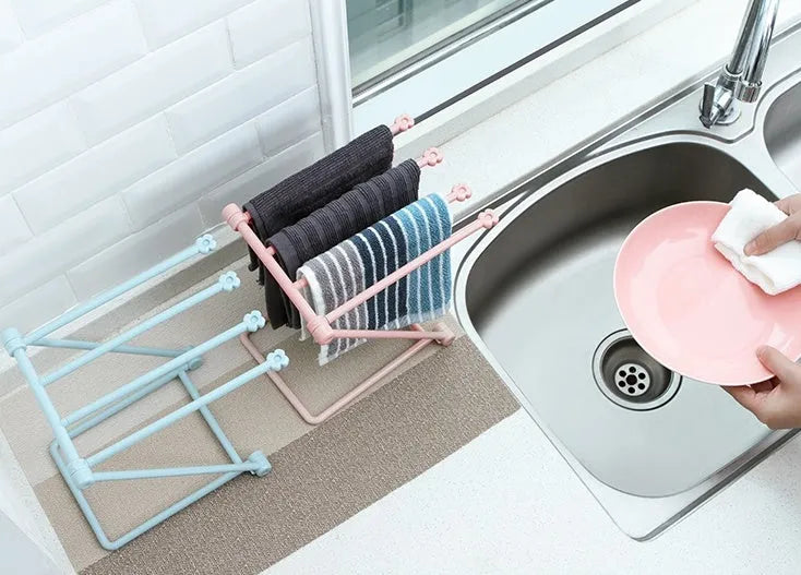 Foldable light grey plastic dishcloth shelf with vertical design mounted on a wall