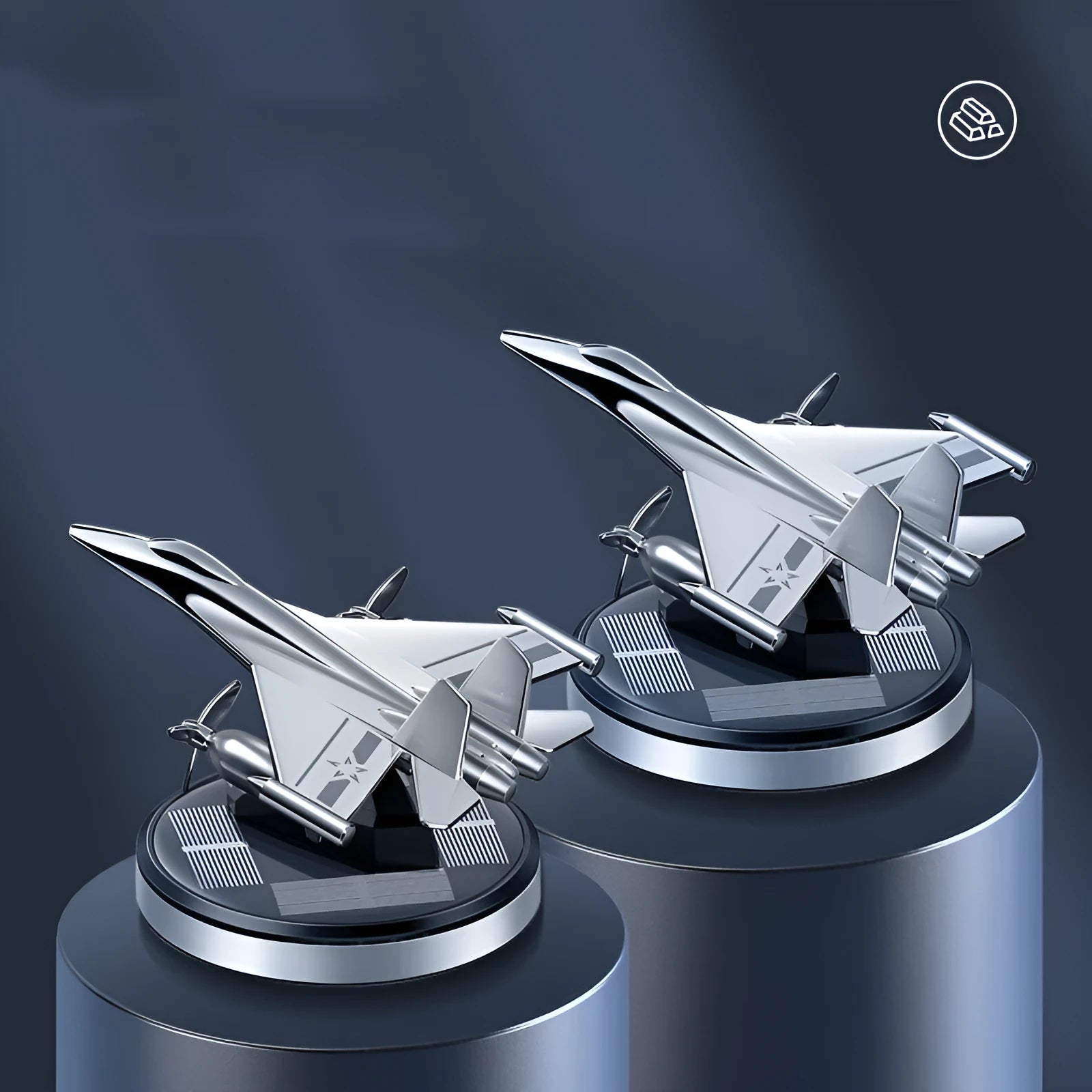 Silver solar-powered rotating fighter aircraft perfume ornament on a desk with essential oil bottle.
