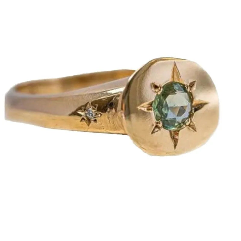 Gold coloured adjustable ring with a star-shaped zircon stone set via micro-inlay on a simple oval band.