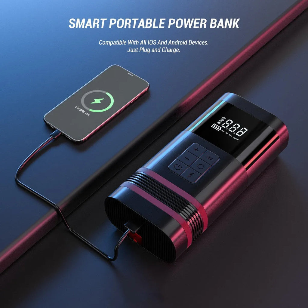 Black portable car jump starter power bank with LED display and attached cables on a grey background