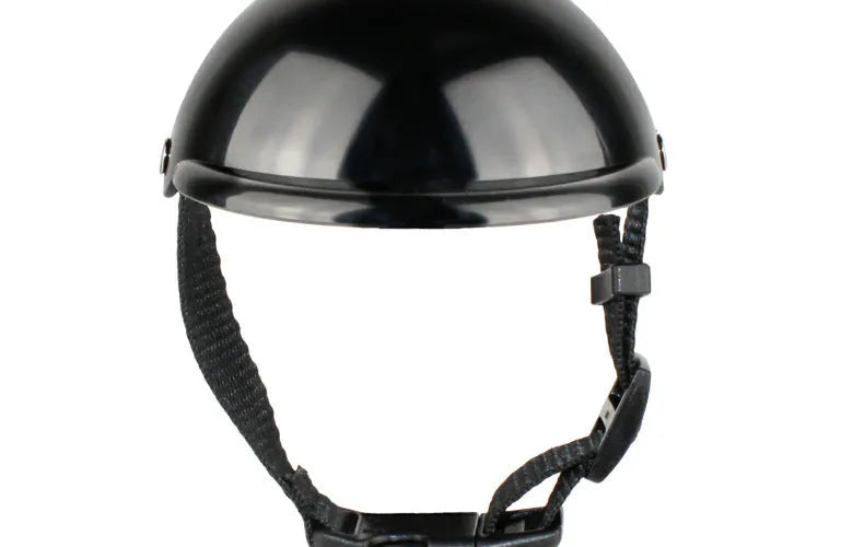 Black pet motorcycle helmet for dog or cat with adjustable strap on a bicycle