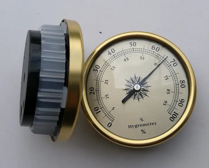 Analogue thermometer and hygrometer with silver aluminium dial and outer ring.