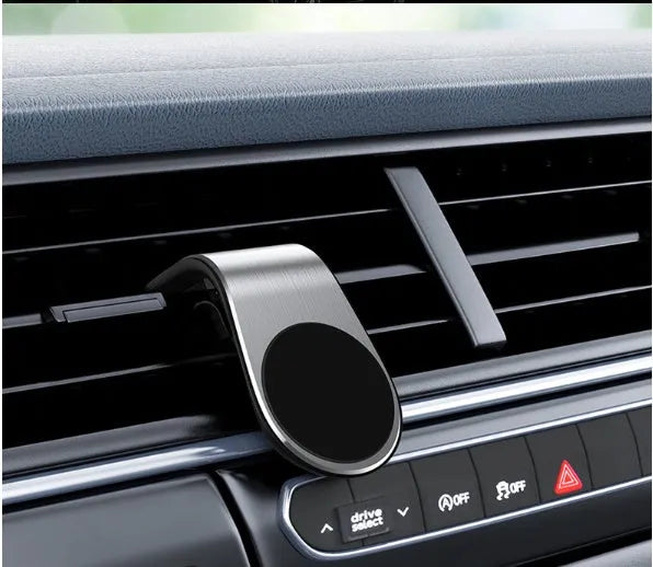 Car phone bracket mounted on vehicle air vent in silver finish showing rotation adjustment