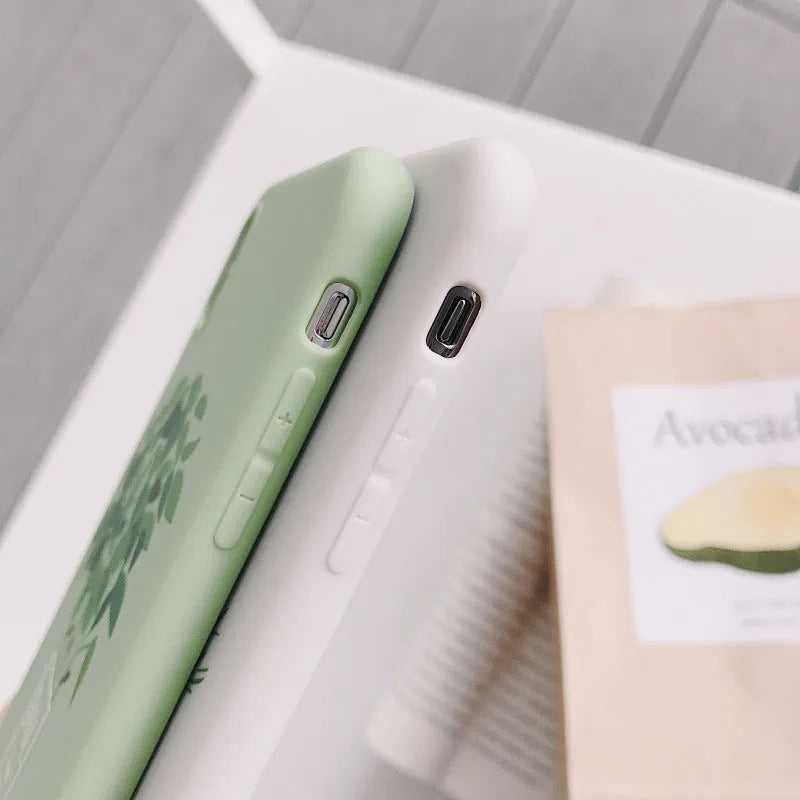 White silicone iPhone case with detailed painted plant design on the back