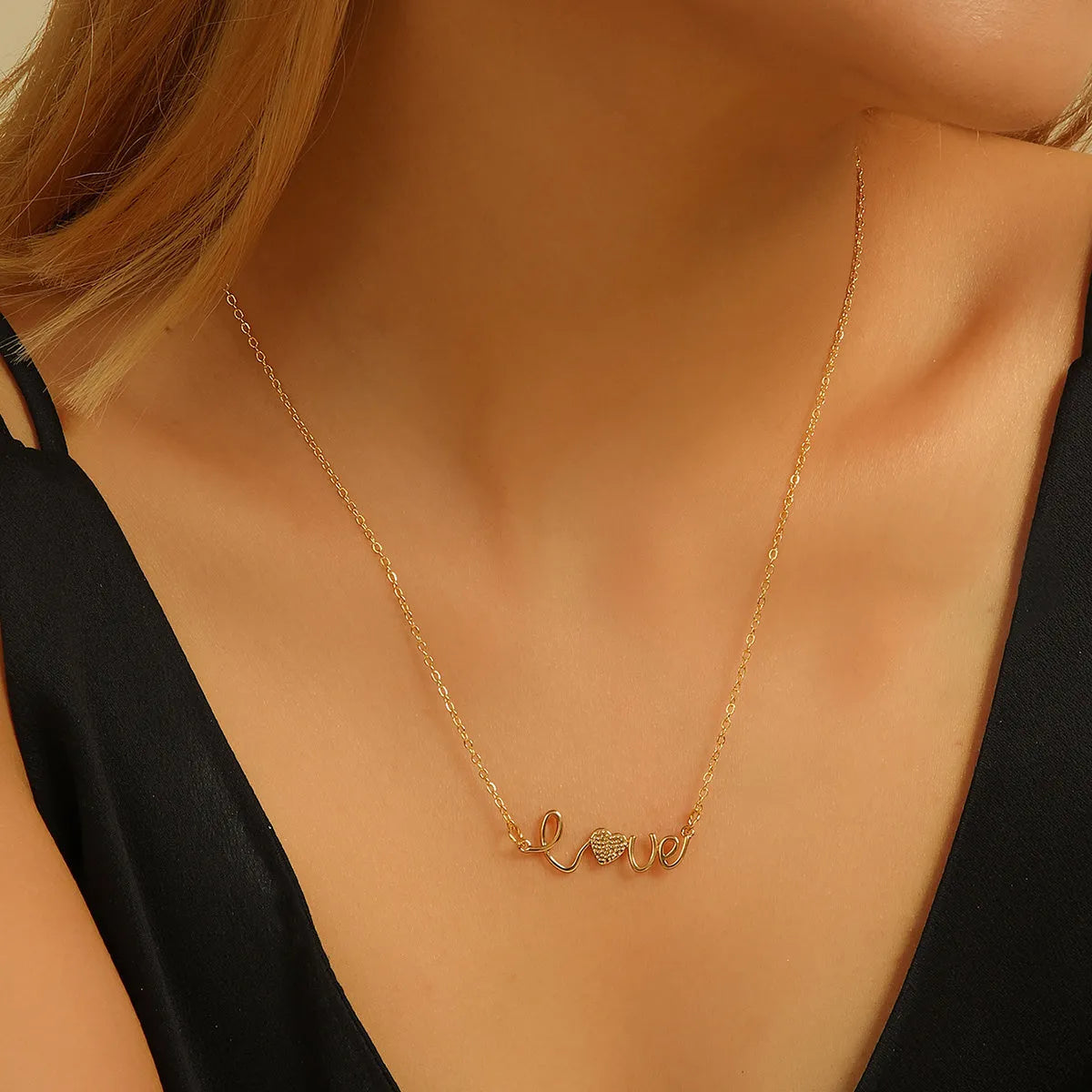 Gold plated copper infinity love pendant necklace with diamond accents and fine chain.