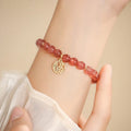 Handmade women's glass bracelet with strawberry quartz beads and blessing card