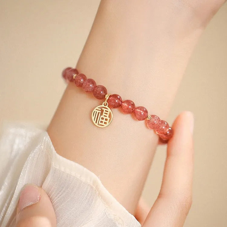 Handmade women's glass bracelet with strawberry quartz beads and blessing card