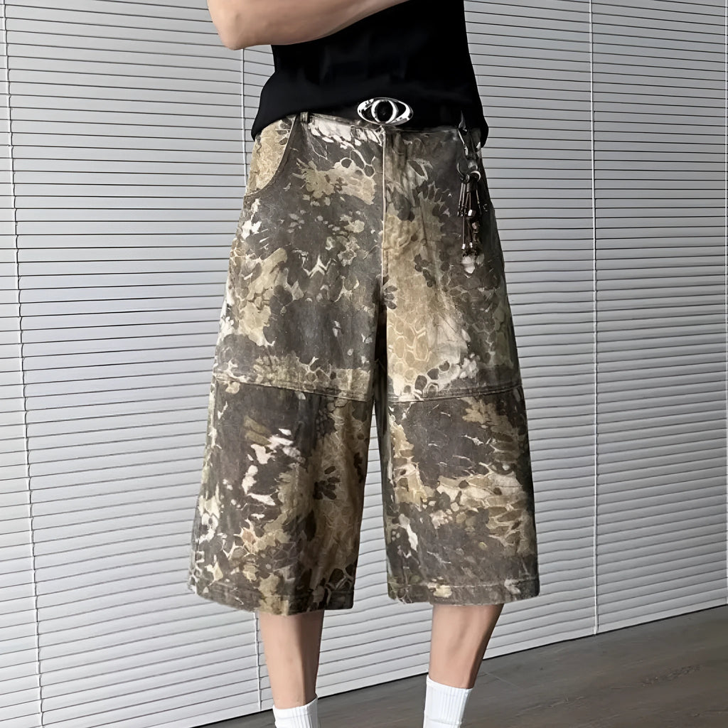 Yellow denim jeans with snake camouflage print and cropped leg length.