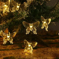 Solar butterfly dragonfly string lights in garden, IP65 rated, warm colour and colourful options.