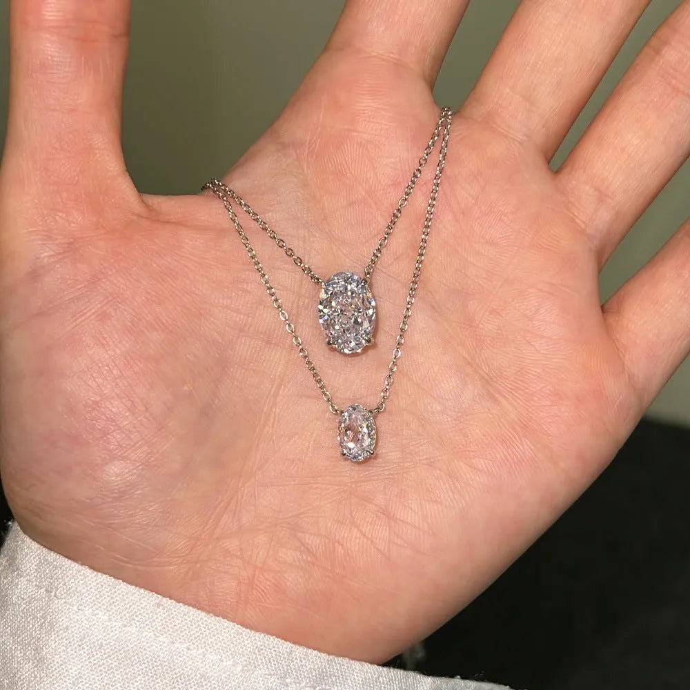 Women's sterling silver necklace with geometric oval ice flower pendant in platinum or gold finish