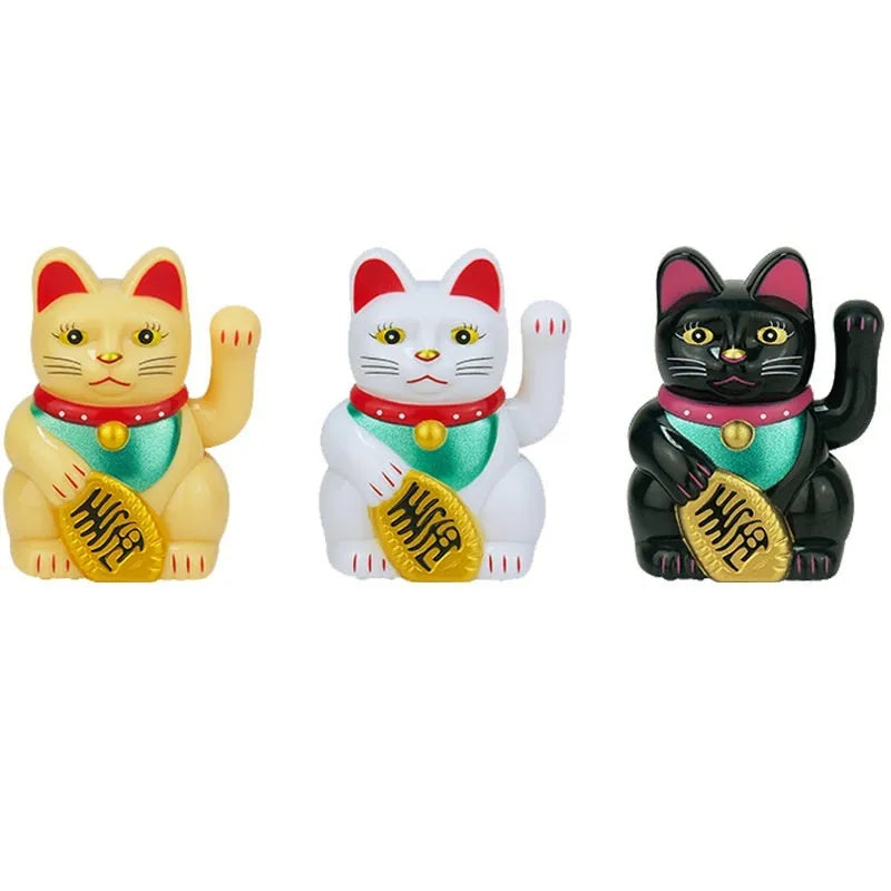 Yellow solar Maneki Neko lucky cat waving its arm on a car dashboard.