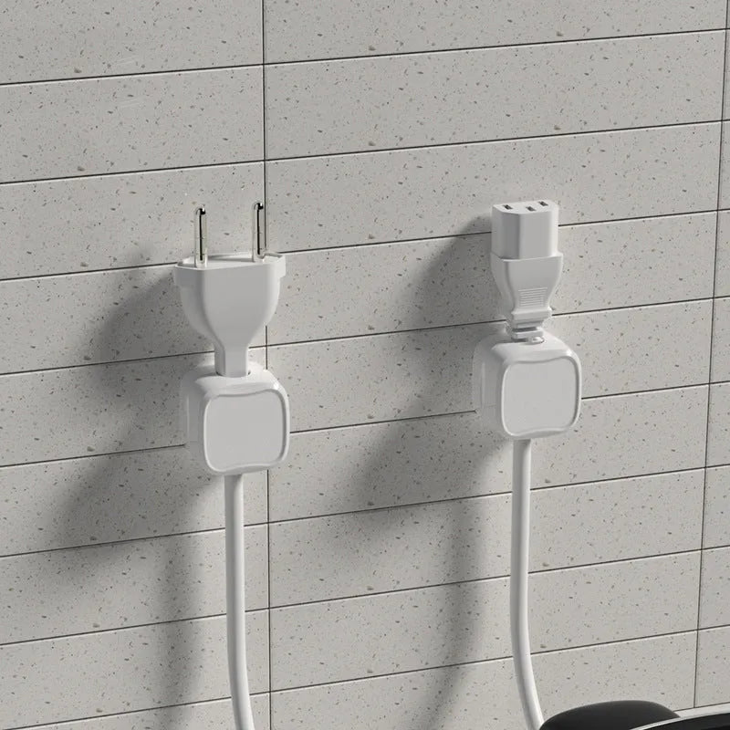 Black and white magnetic cable clips with adhesive backing for under desk cable management.