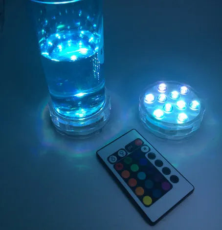 Round white battery-operated LED candle lamp suitable for submersible decoration.