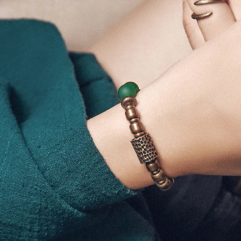 Retro ethnic style couples bracelet made from natural green agate beads on a wrist.