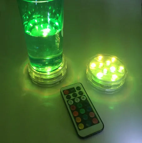 Round white battery-operated LED candle lamp suitable for submersible decoration.