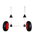 Foldable aluminium kayak trolley with large black pneumatic tyres on a beach, shown carrying a yellow kayak.
