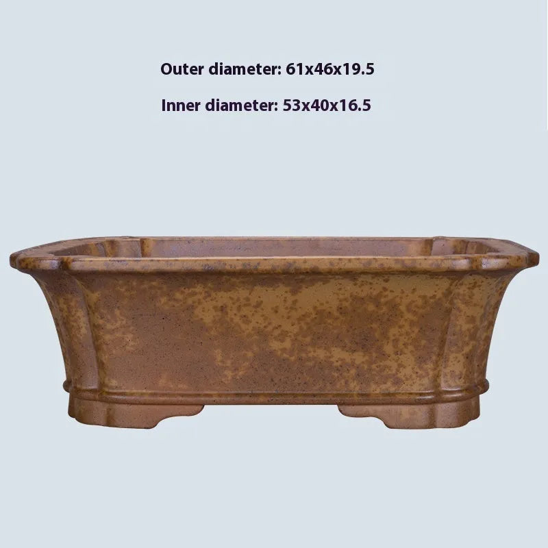 A large, modern rectangular purple sand ceramic flowerpot with sharp angles, shown on a patio.
