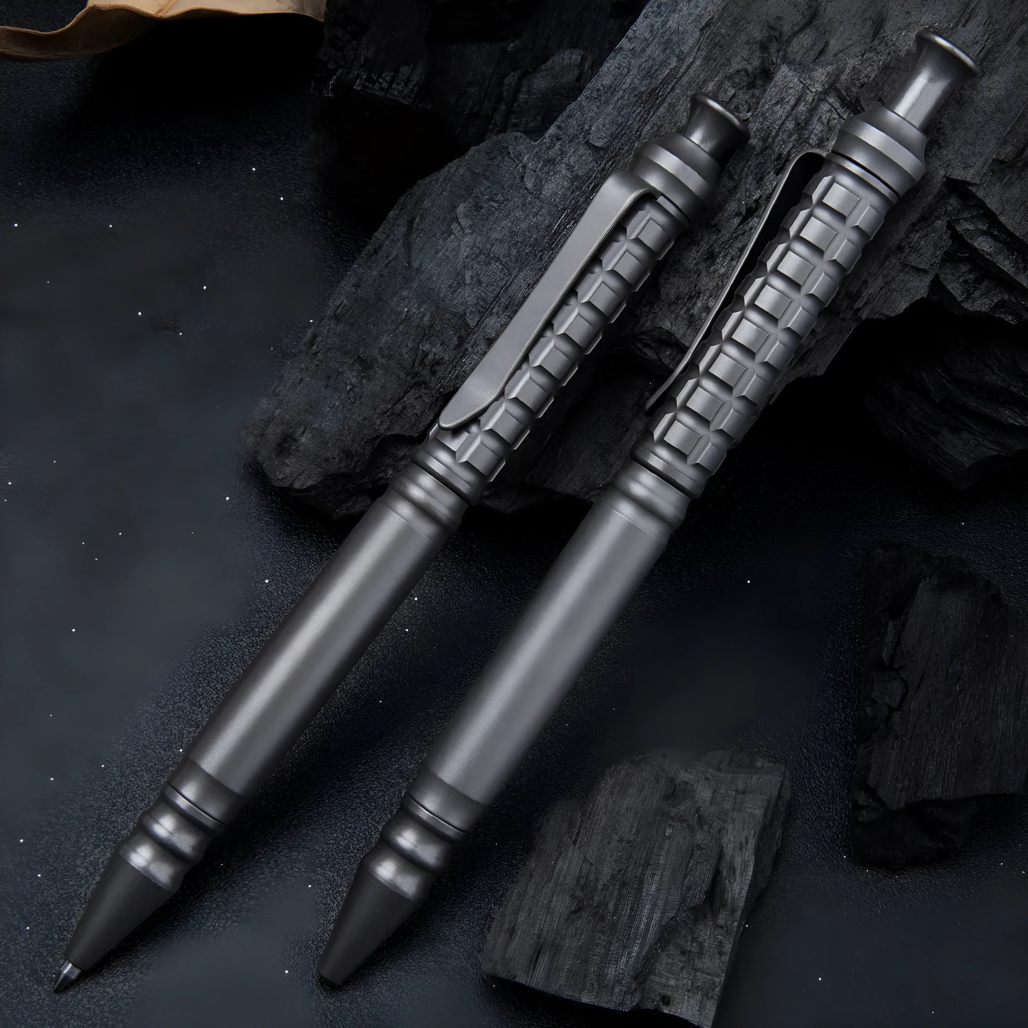 Gunmetal grey titanium alloy tactical pen with push-action mechanism on a gift box.