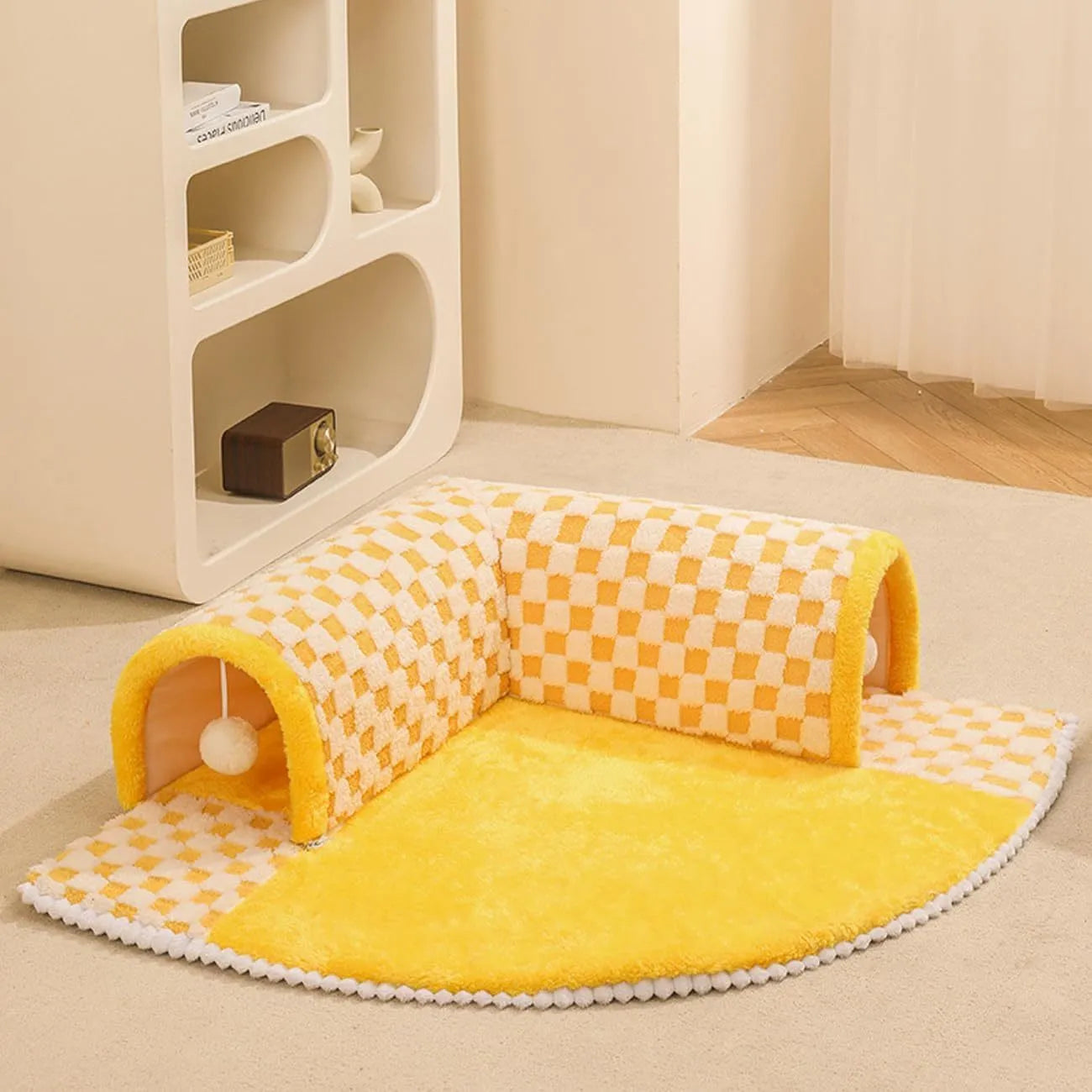 XL sized fan-shaped plush pet bed with an attached tunnel in coffee colour on a wooden floor.