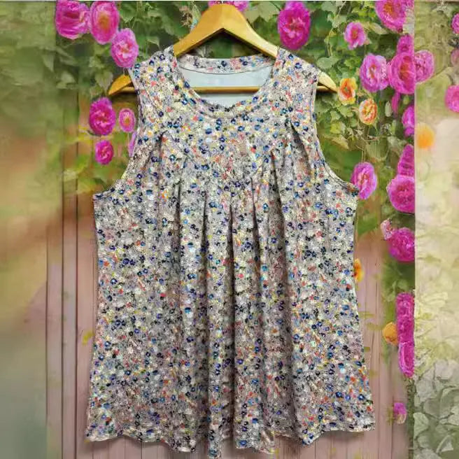 Black plus size floral print sleeveless vest on a hanger, showing loose fit and round neckline.