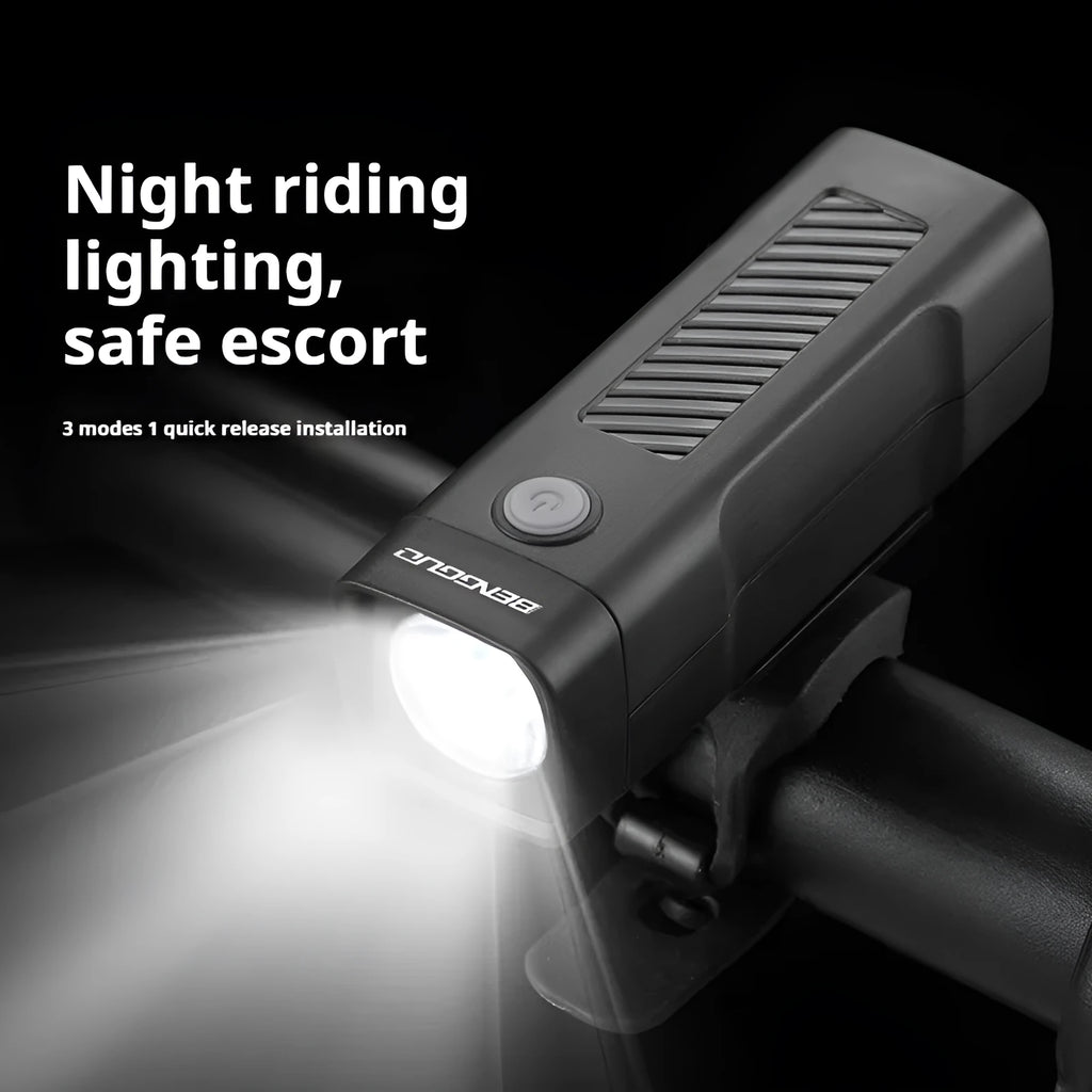 Black USB rechargeable bicycle headlight with quick-release strap mounted on bike handlebars.