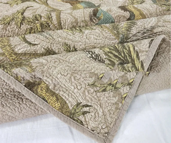 Blue American floral pattern quilted cotton bedspread set on a bed, showing pillowcases.