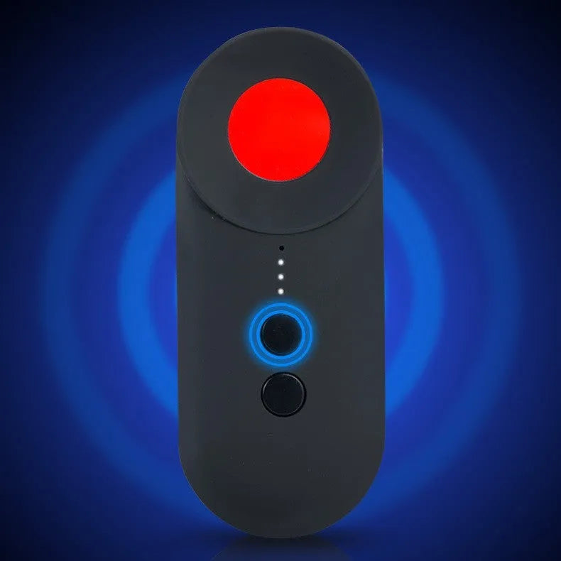 Black portable GPS and hidden camera detector with USB cable on a flat surface.