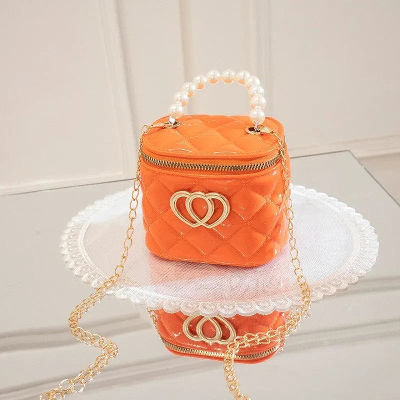PVC bucket-shaped gel bag for women with a heart pattern, shown in apricot colour.