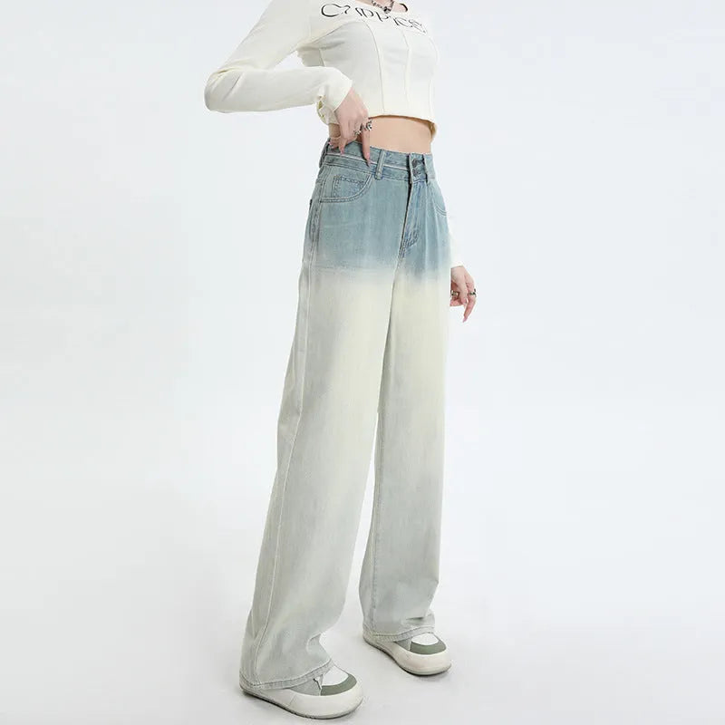 Women's gradient blue wide-leg denim trousers on a neutral background.