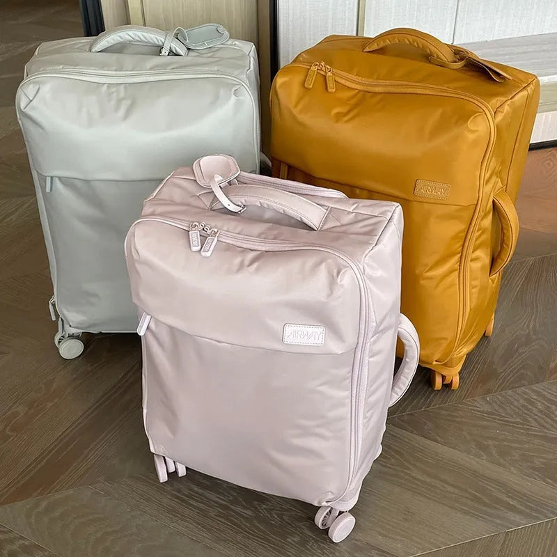 Tea brown coloured ultra-light waterproof Oxford cloth wheeled luggage suitcase in a 20-inch size.