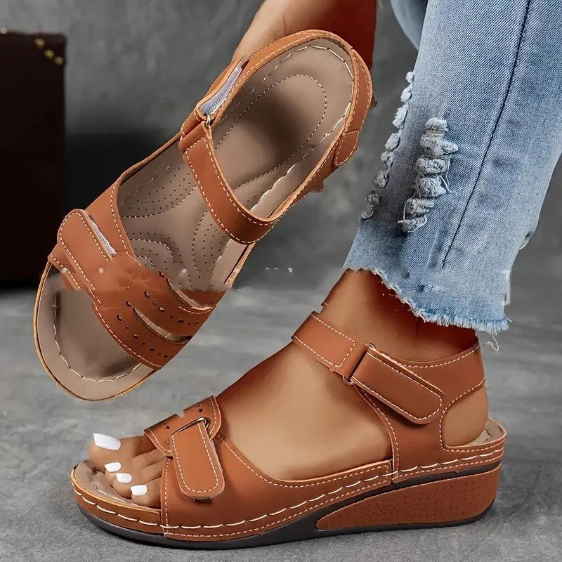 Women's beige strap sandals with thick composite sole and adjustable Velcro fastener on a white background.