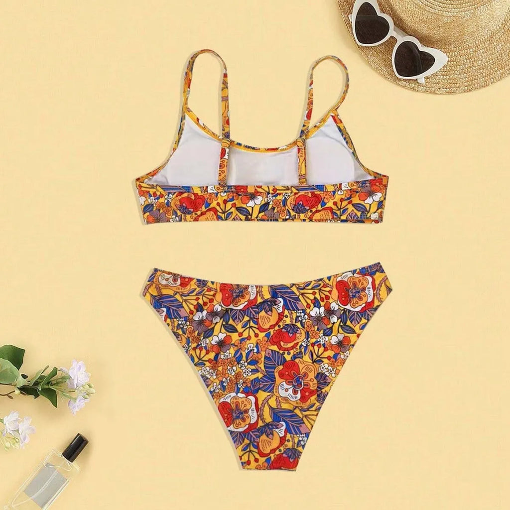 Plus size women's floral print strap bikini swimsuit set in brief style on a mannequin