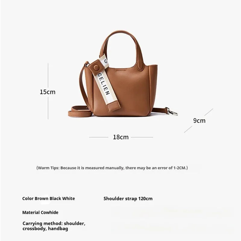 Genuine cattlehide leather retro crossbody bucket bag in black showing external slit pocket and sewing thread detail.