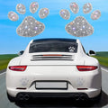 Close-up of a diamond-encrusted glass car sticker showing butterfly and bear claw design options.