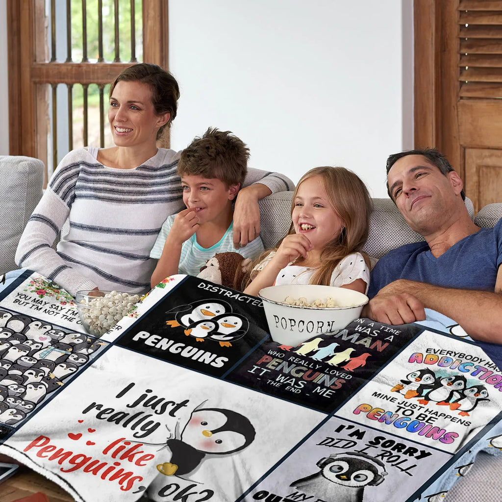 Multicoloured flannel throw blanket with penguin patterns, 130x150cm size on a sofa