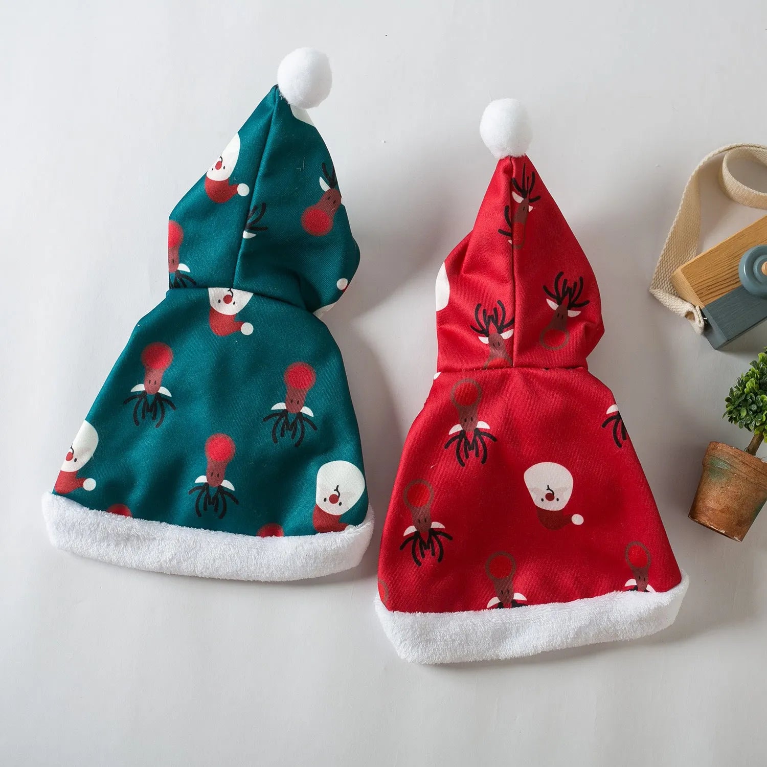 Red deer-print Christmas cloak cape on a cat, showing Little Red Riding Hood style.