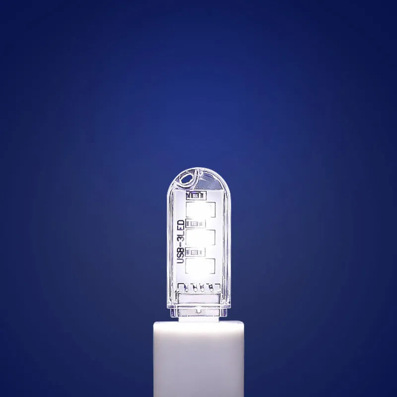Compact white baby night light with USB cable showing dual colour options for nursery use