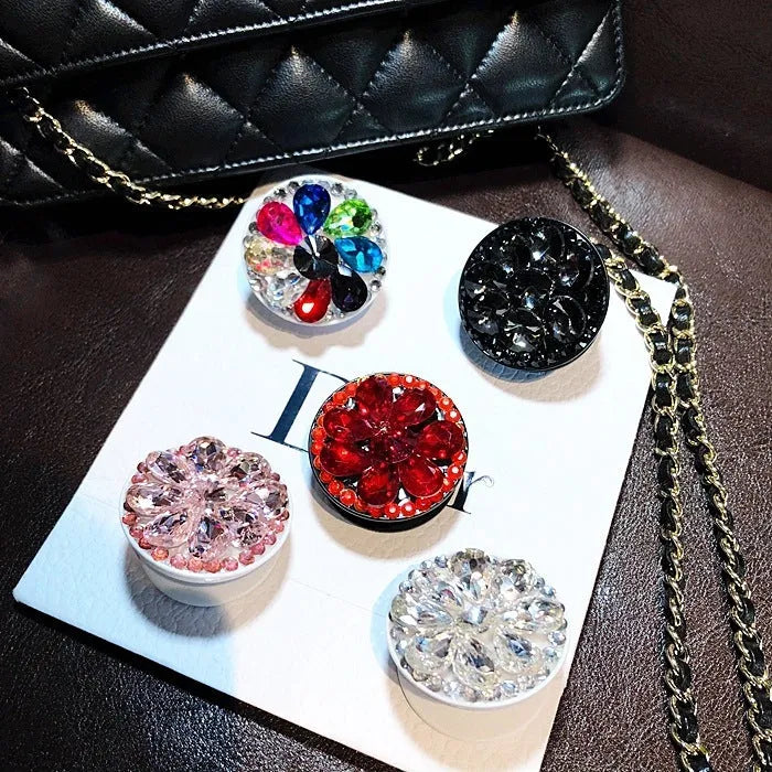 Rhinestone-decorated airbag-style car phone holder with telescopic bracket extended, showing 360-degree swivel mechanism.