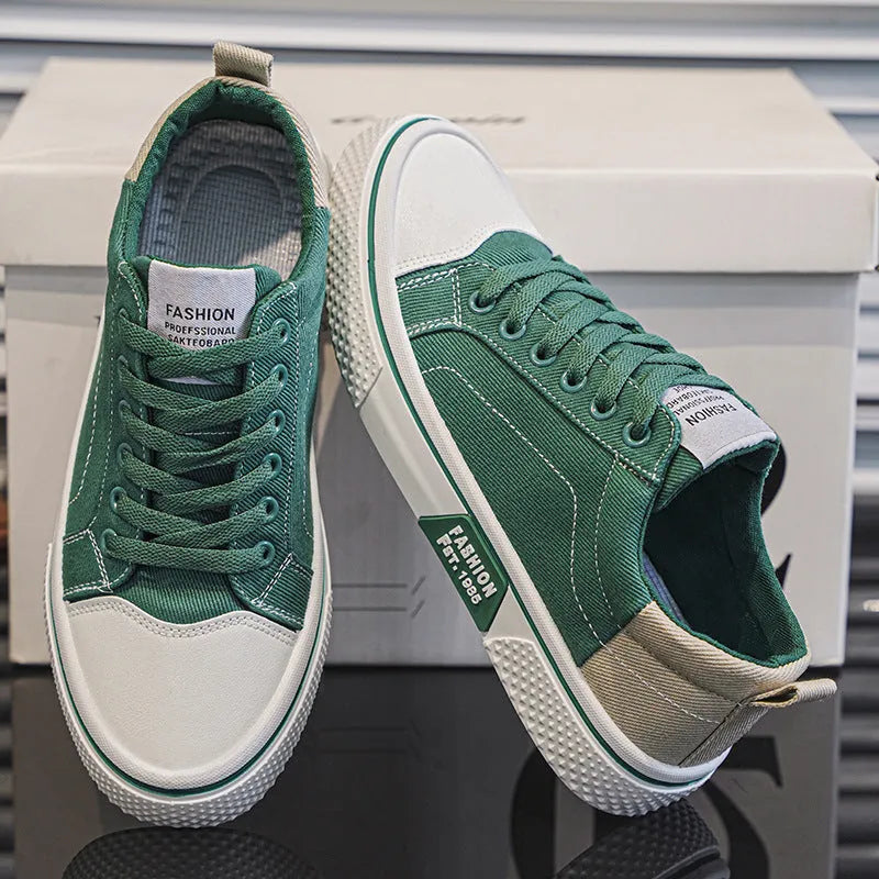 Men's low-top canvas shoes in blue with white sole and lace-up front, on a grey background.