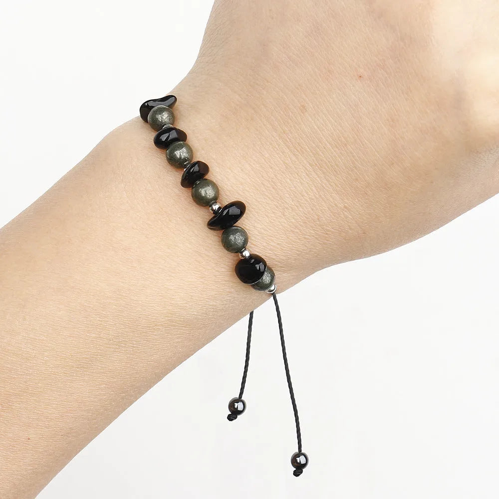 Black garnet stone bracelet with geometric beads and moon charm on wrist