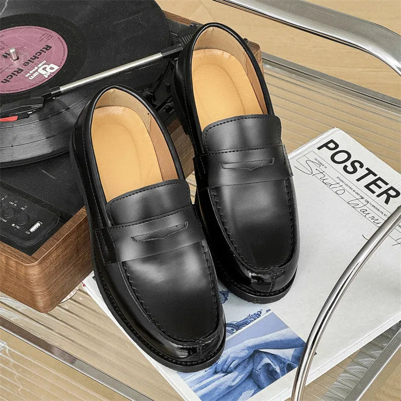 Men's black slip-on derby shoes with rubber sole showing height increasing feature