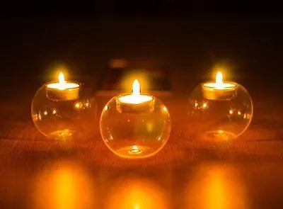 Clear handmade hollow glass spherical candle holder in European style.