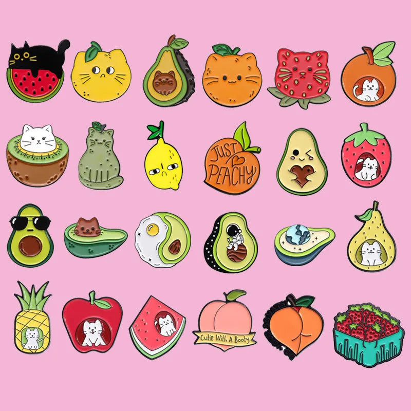 Colourful cartoon fruit design metal brooch with pin clasp on a denim jacket.