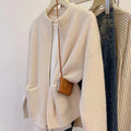 Beige women's long sleeve viscose cardigan sweater coat on a hanger
