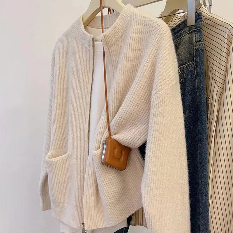 Beige women's long sleeve viscose cardigan sweater coat on a hanger