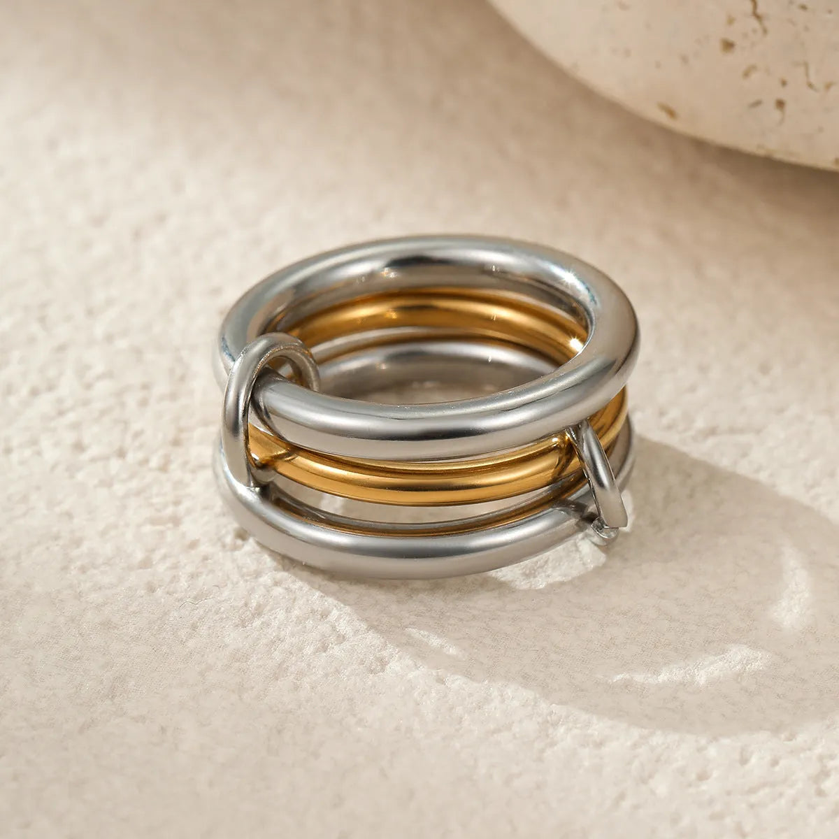 Stacked colour matching stainless steel ring with 18K gold plating on a hand.